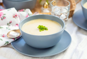 Collagen Potato Leek Soup in a bowl, garnished with chives.