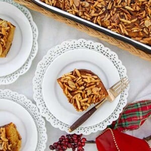 Greek Honey Almond Cake on white plates with decorative edges.
