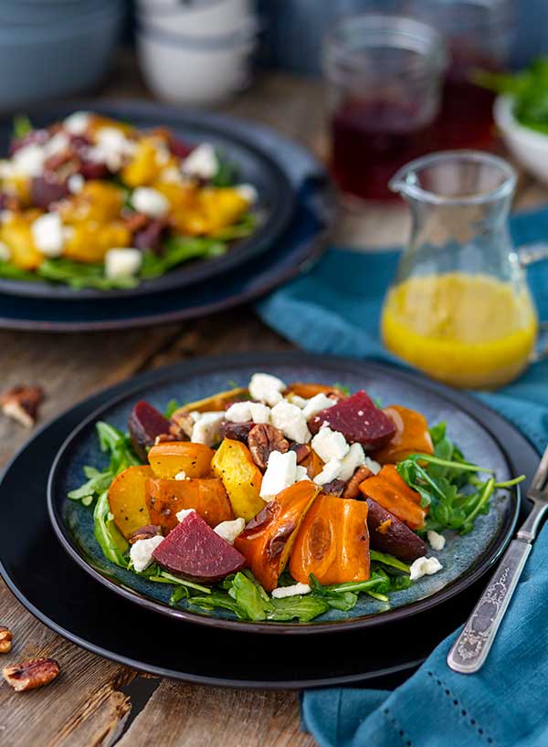 Gluten Free Roasted Acorn Squash Salad recipe on two plates with dressing