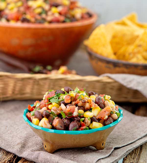 Black Bean Salsa Recipe in a bowl with corn tortilla chips in the background