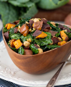 A bowl of Kale Superfood Salad with sweet potatoes.