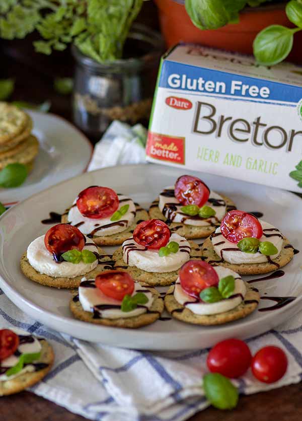 Breton Garlic and Herb Crackers with mozzarella, tomato, and balsamic vinegar drizzled on top