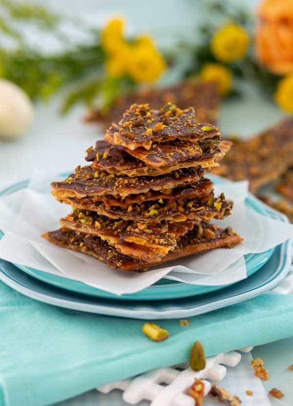 Caramel Matzo Brittle stacked on a blue plate.