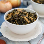 Healthy Southern Collard Greens in a white bowl on an elegant white plate