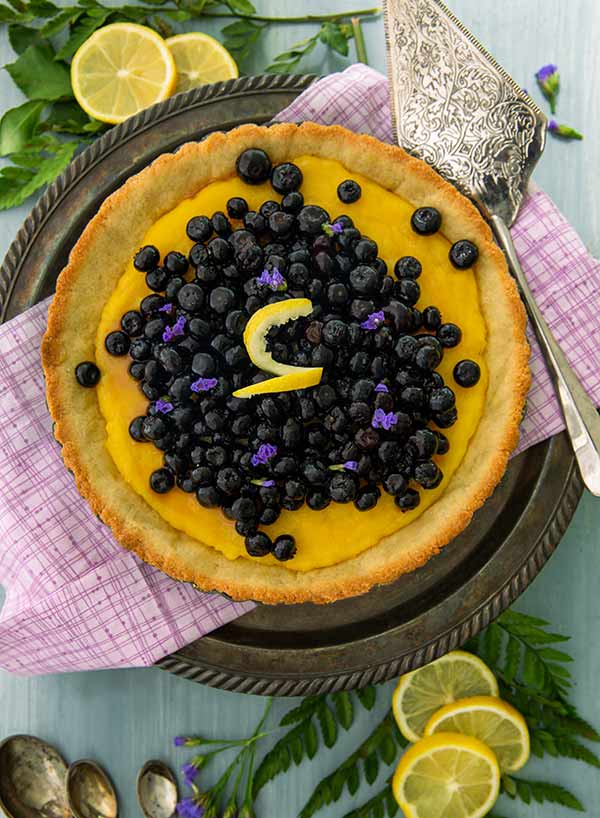 Lemon Blueberry Pie Recipe topped with fresh blueberries and lemon zest.