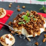 Sugar Free French Quarter Cheese Spread with pecans on top, sliced into on a serving platter