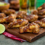 Sweet and Spicy Wings on a wooden cutting board
