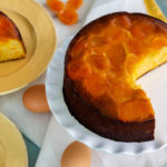 Sugar-Free & Grain-Free Almond Apricot Cake on a white serving platter with a slice cut out
