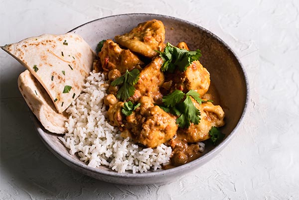 Breaded Butter Cauliflower with white rice and naan in a bowl