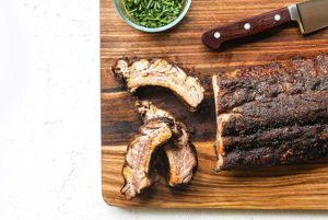 Dry-Rubbed Ribs on a wooden cutting board