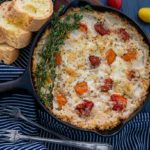 Goat Cheese with Tomatoes Dip in a cast iron skillet