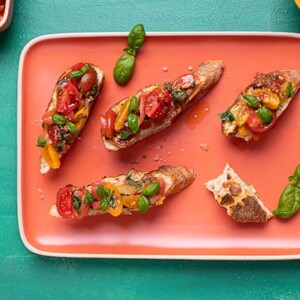 Tomato Bruschetta on a coral-colored platter