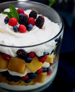 Gluten-Free Lemon Berry Trifle in a glass dish topped with fresh berries and mint