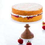 Victoria Sponge Cake on a wooden cake pedestal
