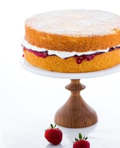 Victoria Sponge Cake on a wooden cake pedestal