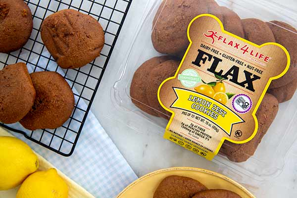 Flax4Life Lemon Zest Cookies in a package and on a wire cooling rack with lemons on the side