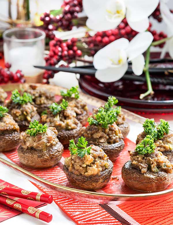 Teriyaki Stuffed Mushrooms on a serving platter with red decor