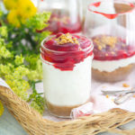 Gluten-Free Cherry Cheesecake-in-a-Jar with bright yellow flowers in the background