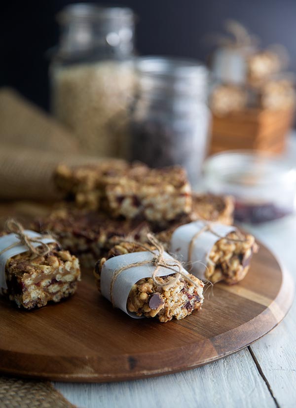 Chocolate Cherry Crispy Rice Treats wrapped in parchment on a wooden board