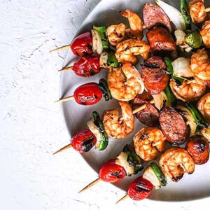 Shrimp and Andouille Sausage Skewers on a white plate