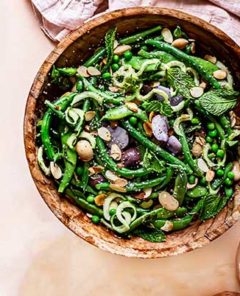 Summer Green Bean Potato Salad in a wooden bowl with a light pink cloth napkin underneath