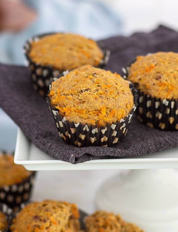 Carrot Cake Muffins in black and white polka dot muffin wrappers on top of a white cake pedestal