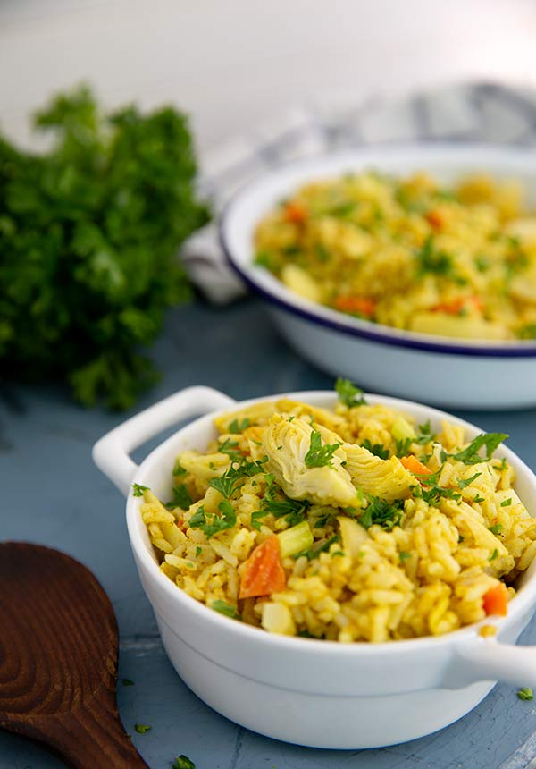 Curried Rice Salad in a white bowl with handles on both sides