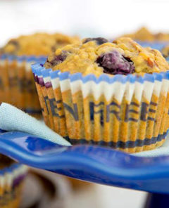 Double Berry Pecan Muffins on a royal blue cake pedestal