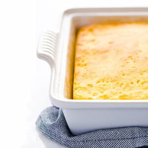 Gluten-Free Sourdough Cornbread in a white ceramic baking dish against a white background