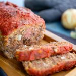 Italian-Style Meatloaf on top of a wooden serving tray