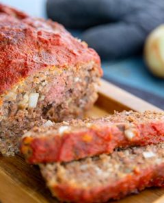 Italian-Style Meatloaf on top of a wooden serving tray
