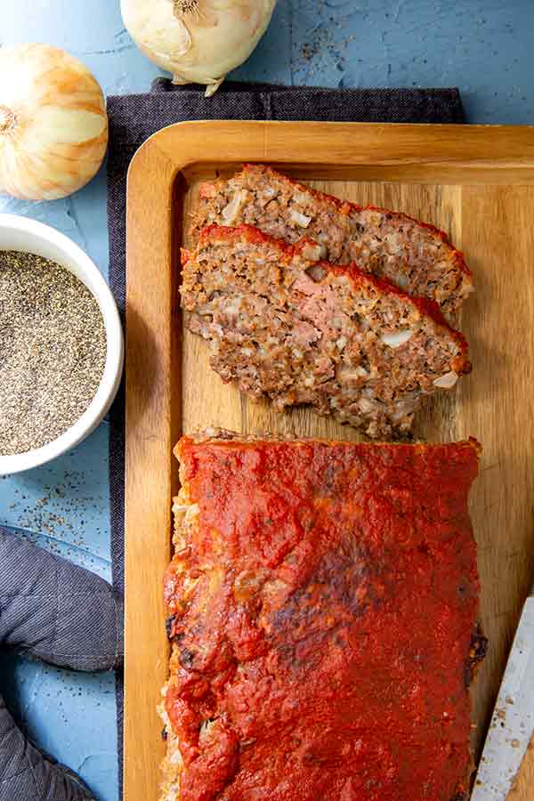 Overhead shot of Italian-Style Meatloaf on a wooden serving board