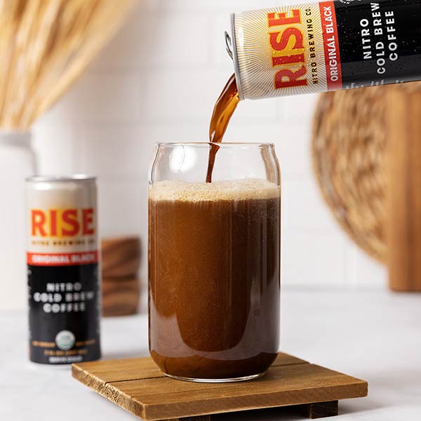 Rise Cold Brew Coffee being poured from the can into a glass