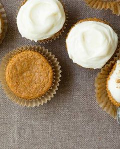 Sweet Potato Cupcakes with white creamy frosting on a burlap background