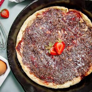 Chocolate and Strawberry Baked Pancake in a cast iron skillet with fresh strawberries on top