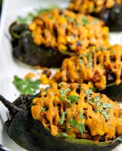 Closeup of Stuffed Poblano Peppers on a white serving platter