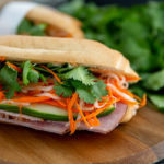 Closeup of gluten-free Banh Mi Sandwich on a wooden cutting board