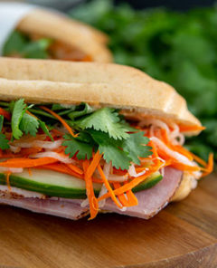 Closeup of gluten-free Banh Mi Sandwich on a wooden cutting board