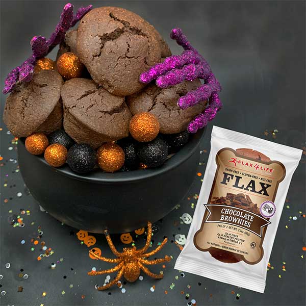 Flax4Life Chocolate Brownies in a black bowl with skeleton hands and spiders decorating for Halloween