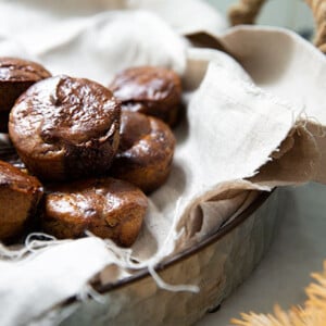 Chocolate Flourless Muffins in a silver pan with beige rustic napkin inside the pan