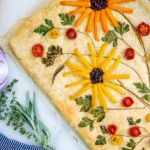 Garden Focaccia bread decorated with vegetables and herbs on top to look like flowers