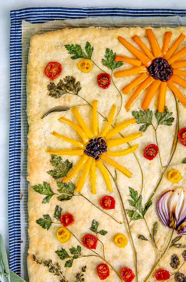 Garden Focaccia bread decorated with vegetables and herbs on top to look like flowers