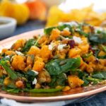 Closeup of a Butternut Squash and Kale Fall Salad on a bronze oval serving platter