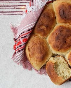 Closeup of Pull-Apart Potato Rolls with red linen napkin and table cloth