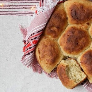 Closeup of Pull-Apart Potato Rolls with red linen napkin and table cloth