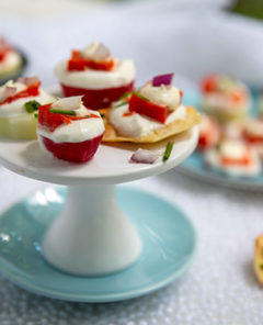 Smoked Salmon & Chive Bites on a miniature white pedestal on top of a light blue plate