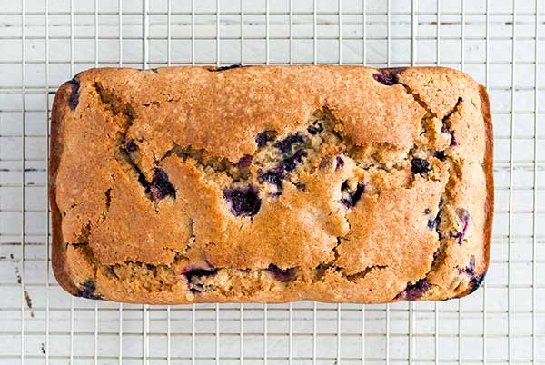 Overhead view of Blueberry Muffin Bread loaf on a wire rack