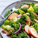Kale Apple Salad on a gray plate with a silver fork