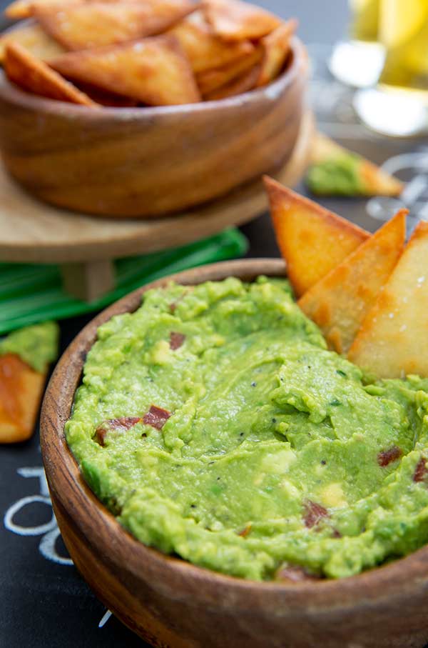 Closeup of Keto Chips and Guacamole in wooden bowls