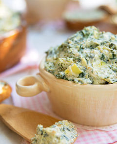 Easy Stovetop Spinach and Artichoke Dip in a white ramekin on a light pink and white checkered napkin
